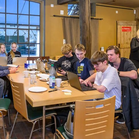 Eine Gruppe arbeitet konzentriert an Laptops bei einem Workshop im Tuppenhof in Kaarst.