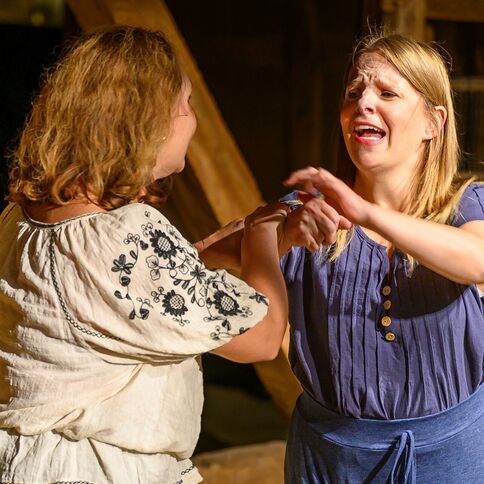 Zwei Frauen sind emotional in ein Gespräch vertieft, während sie auf dem Tuppenhof in Kaarst stehen.